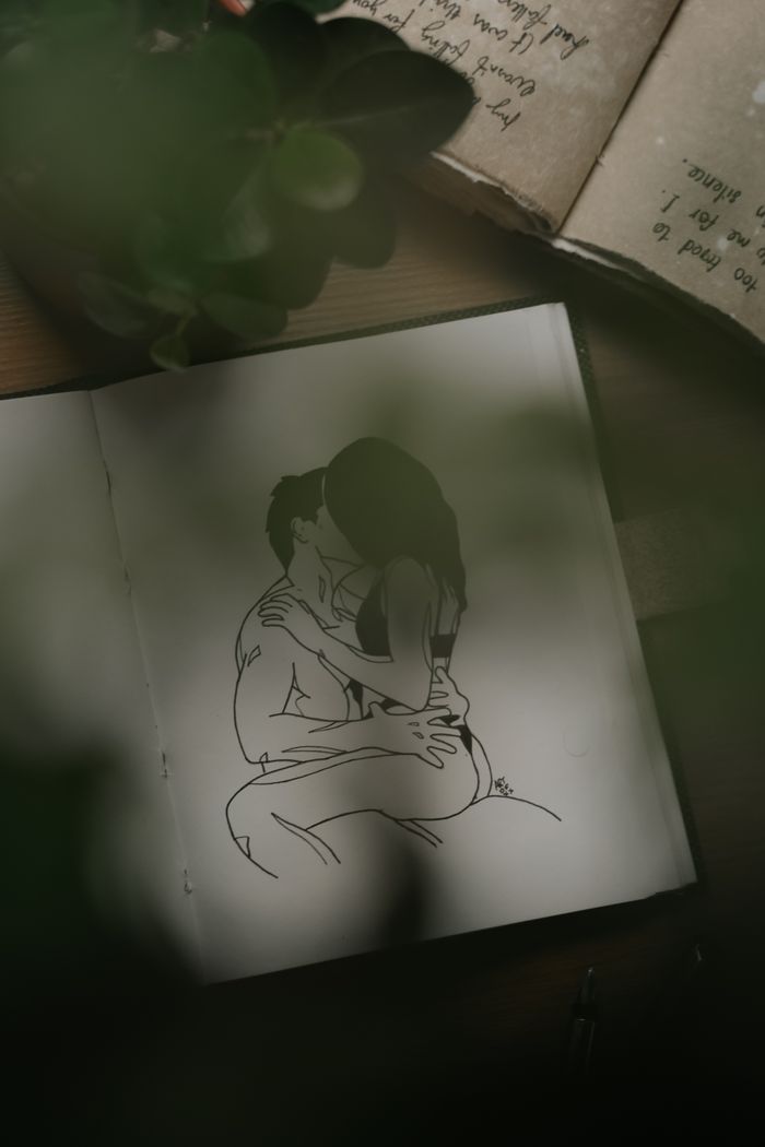 Mastering the First Impression: Your intriguing post title goes here A close-up image showing a romantic drawing of a couple embracing, captured in a dimly lit setting.